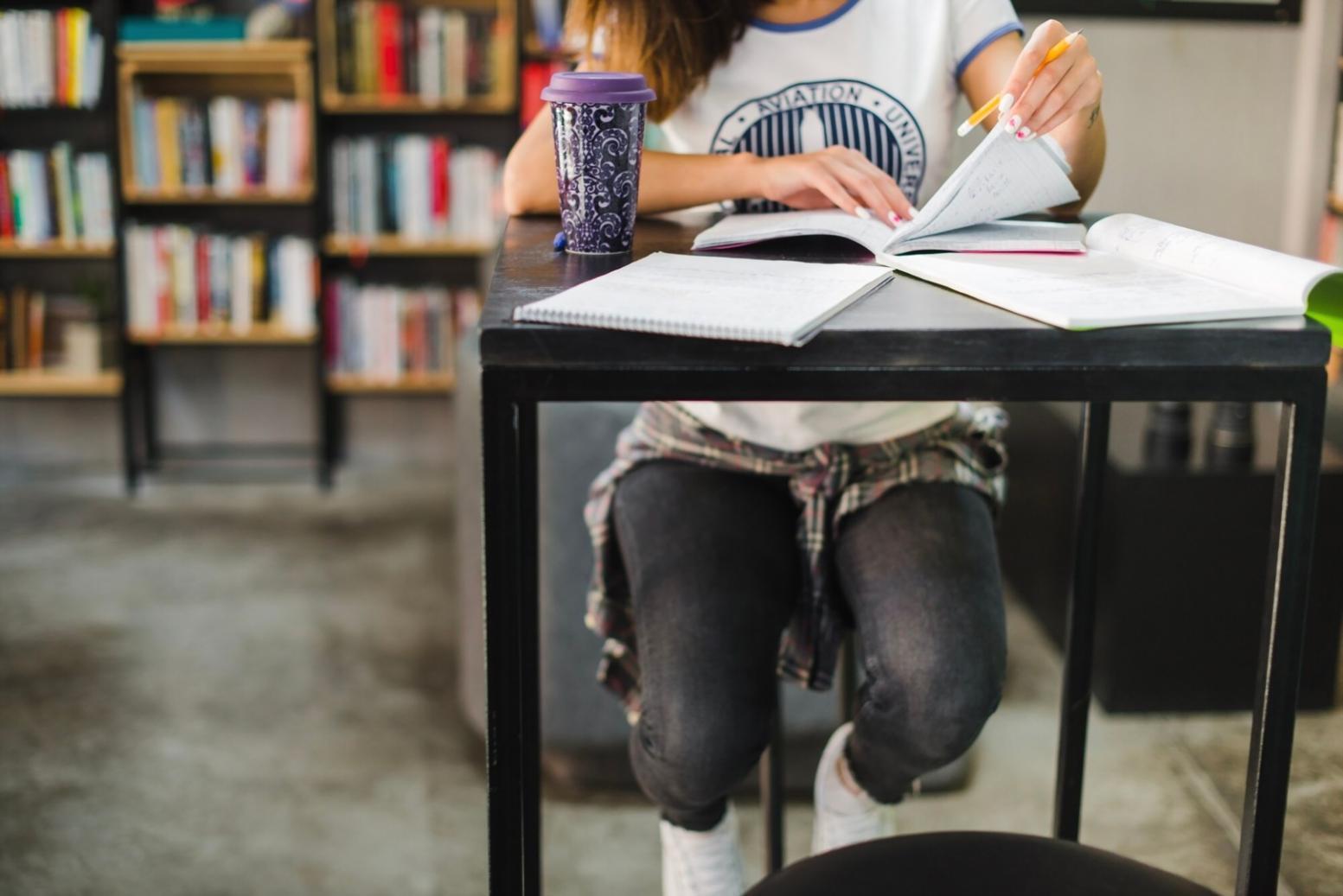 Experienced barber instructor guiding student through precision cutting techniques